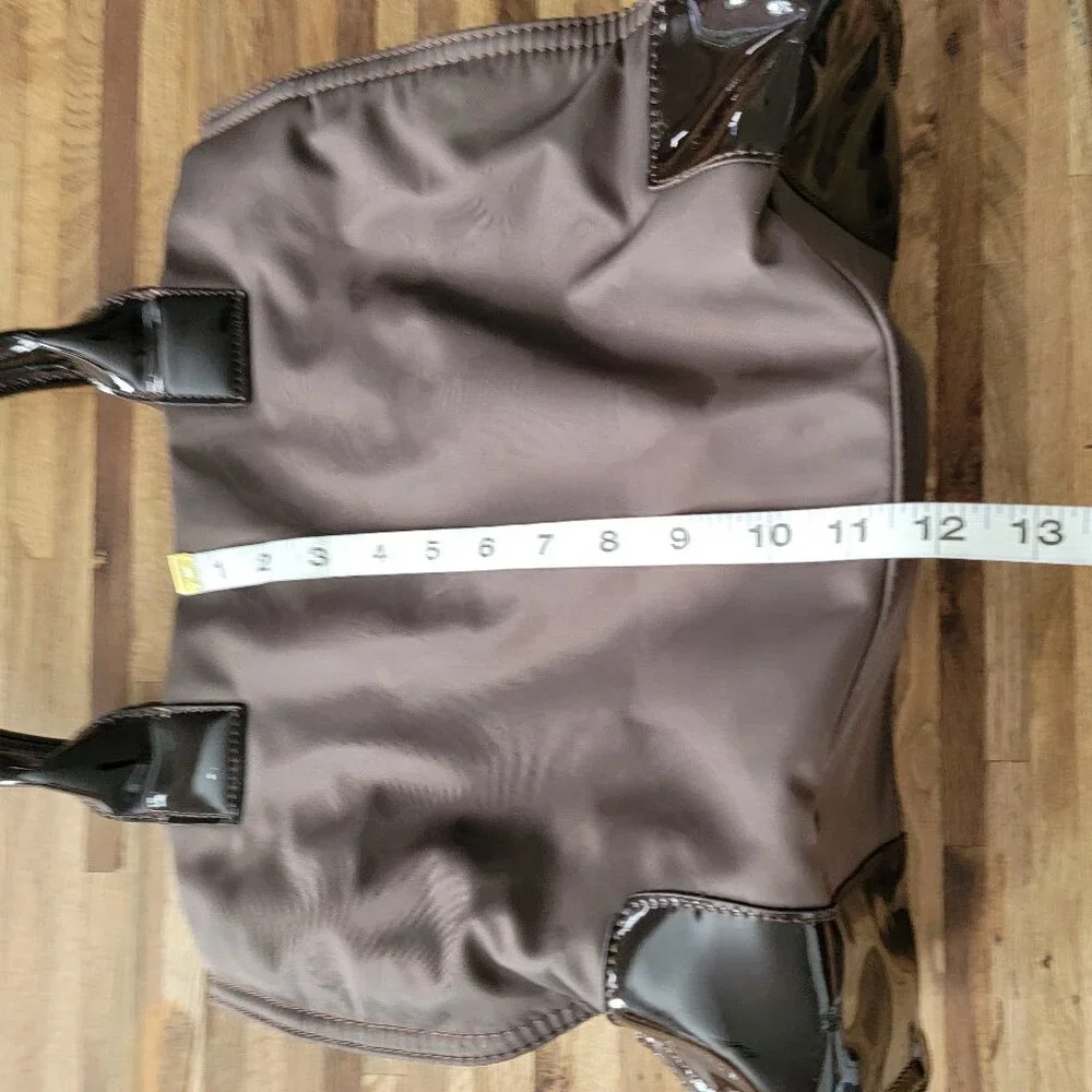 Tory Burch Ella nylon tote bag with patent leather trim and a large logo patch.